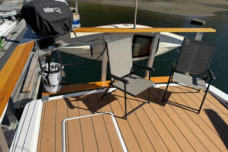 Sea Wolf Yacht Photos Pics Deck of 1994 Bayliner 4788 Pilot House Motoryacht with chairs and a grill.