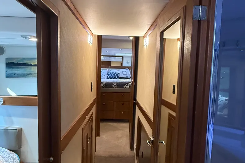 Sea Wolf Yacht Photos Pics Interior hallway of a 1994 Bayliner 4788 Pilot House Motoryacht, featuring wood paneling and cozy decor.