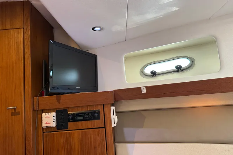 Sea Wolf Yacht Photos Pics 1994 Bayliner 4788 Pilot House Motoryacht interior with TV and porthole window.