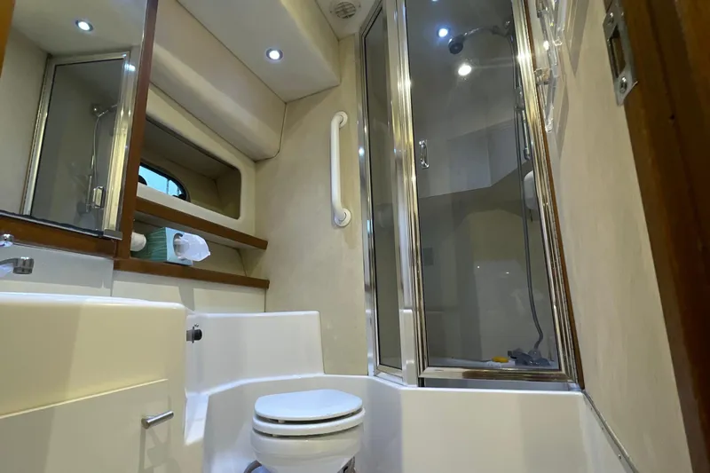 Sea Wolf Yacht Photos Pics Luxurious bathroom in 1994 Bayliner 4788 Pilot House Motoryacht with shower and modern fixtures.