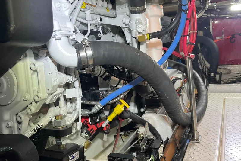 Sea Wolf Yacht Photos Pics Engine room of 1994 Bayliner 4788 Pilot House Motoryacht with visible hoses and components.