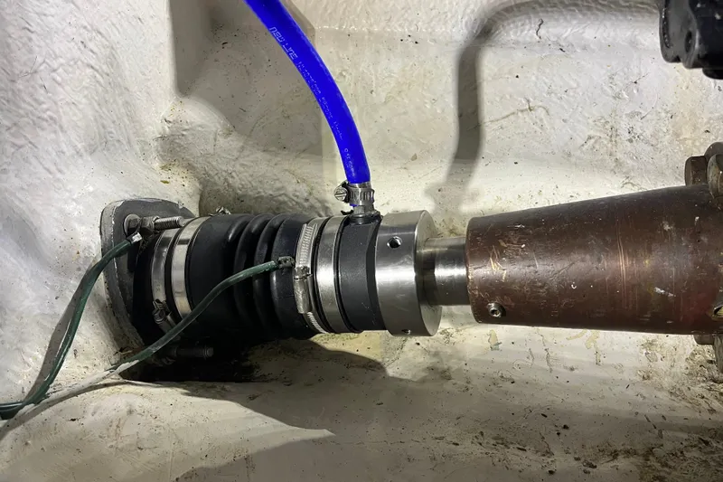 Sea Wolf Yacht Photos Pics Bayliner 4788 Pilot House Motoryacht 1994 engine shaft with blue hose and metal fittings.