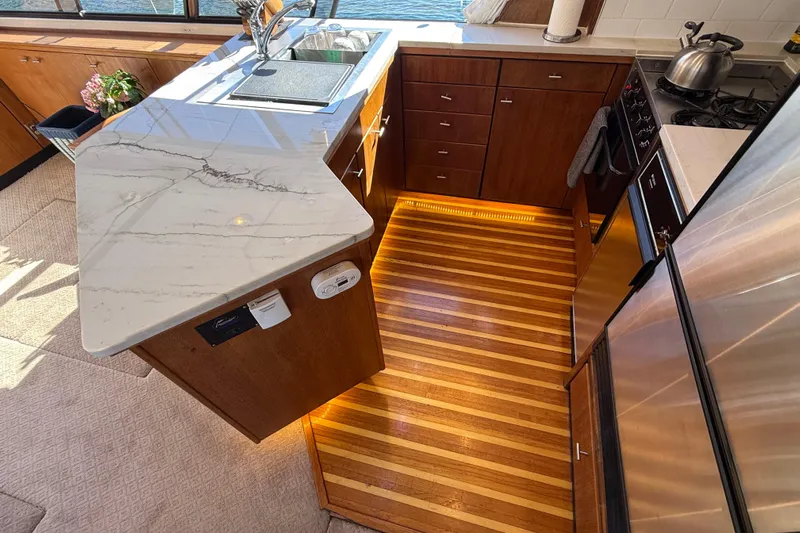 Sea Wolf Yacht Photos Pics Luxurious kitchen interior of 1994 Bayliner 4788 Pilot House Motoryacht with marble countertop.