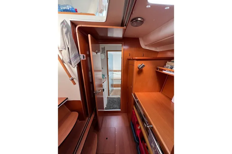 Alego Yacht Photos Pics Interior of 2007 Lagoon 380 S2 yacht with wooden cabinetry and open door.