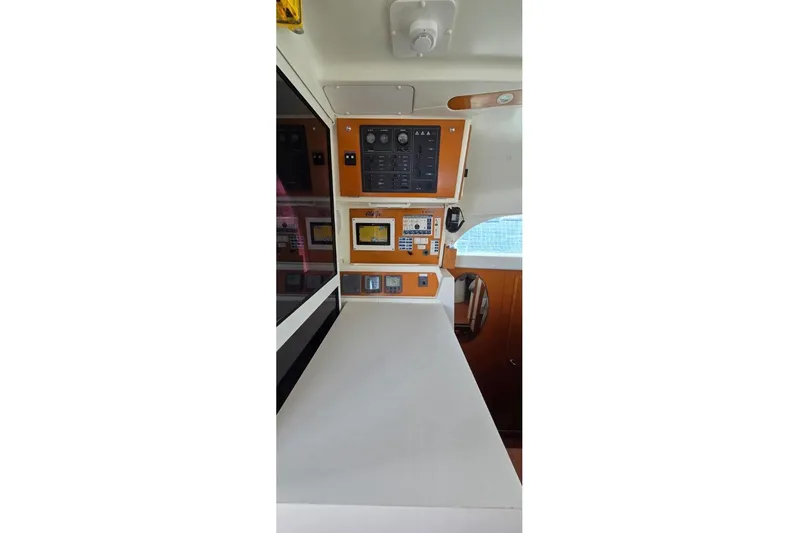 Alego Yacht Photos Pics Control panel inside 2007 Lagoon 380 S2 catamaran, featuring navigation and communication equipment.