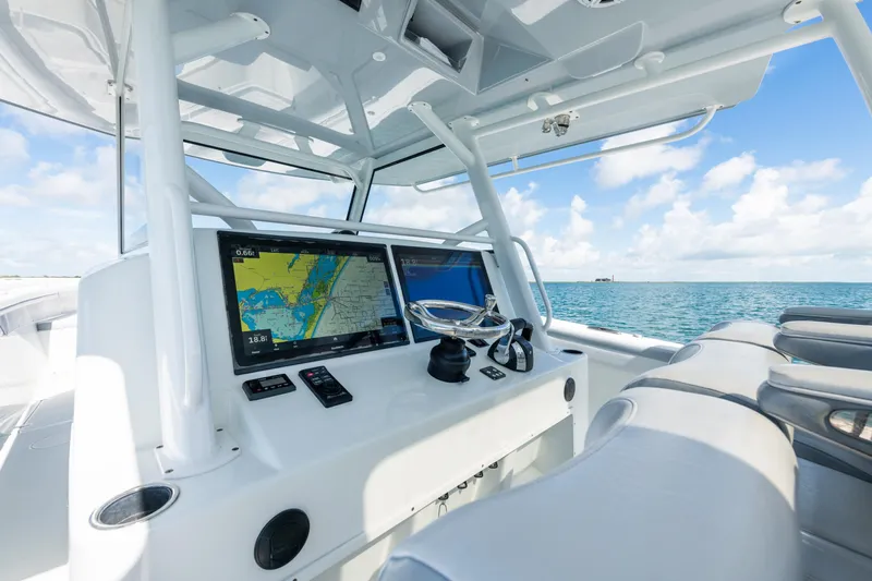  Yacht Photos Pics 2019 Yellowfin 42 Center Console boat interior with navigation screens, ocean view.
