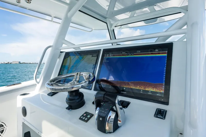  Yacht Photos Pics 2019 Yellowfin 42 Center Console helm with dual navigation screens and steering wheel.