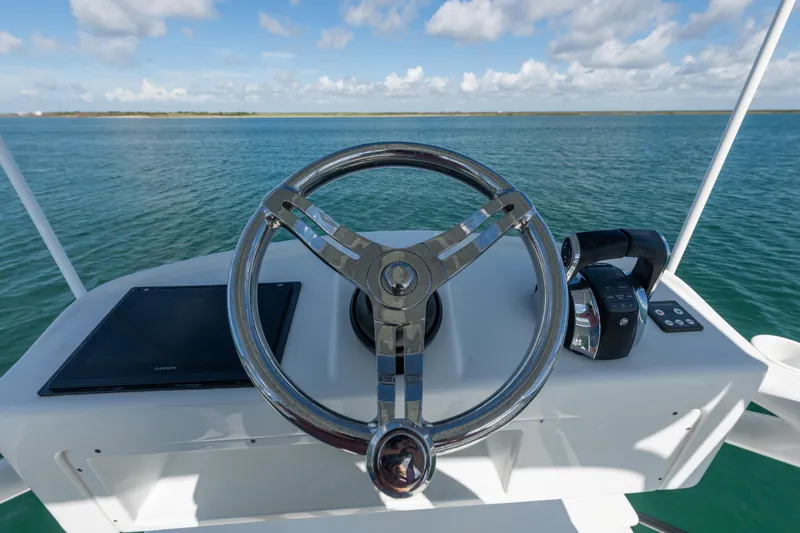  Yacht Photos Pics Steering wheel of 2019 Yellowfin 42 Center Console boat on open water.