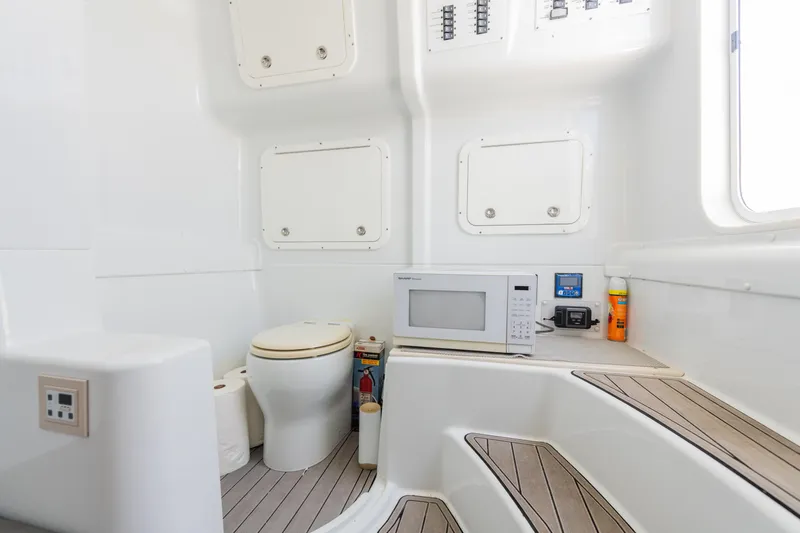  Yacht Photos Pics 2019 Yellowfin 42 Center Console interior with toilet, microwave, and storage compartments.