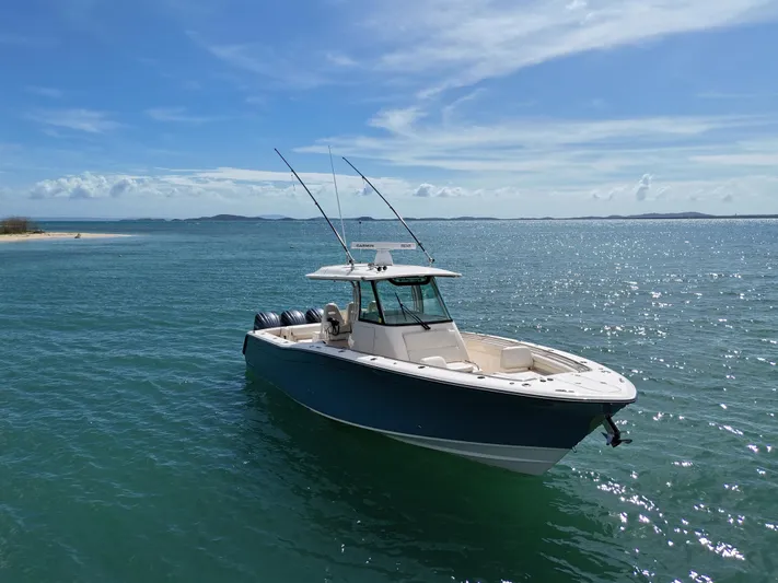  Yacht Photos Pics 2021 Grady-White Canyon 336 boat on clear blue water under a sunny sky.