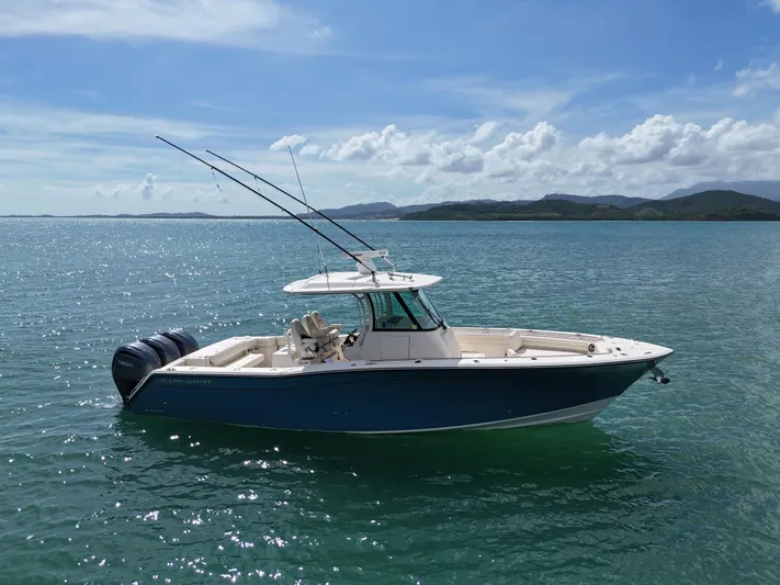  Yacht Photos Pics 2021 Grady-White Canyon 336 boat on calm water under blue sky.