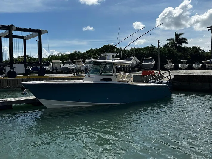  Yacht Photos Pics 2021 Grady-White Canyon 336 boat docked in marina under blue sky.