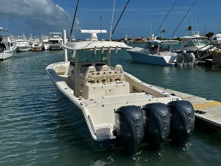  Yacht Photos Pics 2021 Grady-White Canyon 336 boat docked with triple outboard engines.