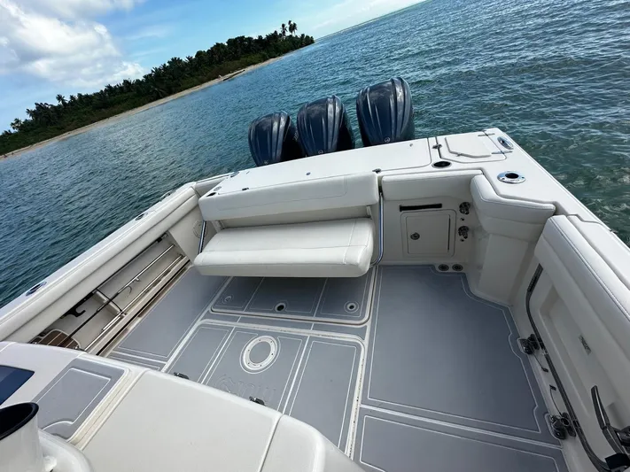  Yacht Photos Pics 2021 Grady-White Canyon 336 boat deck with triple engines, near tropical shoreline.