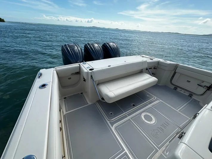  Yacht Photos Pics 2021 Grady-White Canyon 336 boat deck with triple outboard motors on open water.