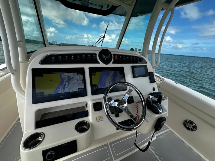  Yacht Photos Pics 2021 Grady-White Canyon 336 helm with navigation screens and ocean view.