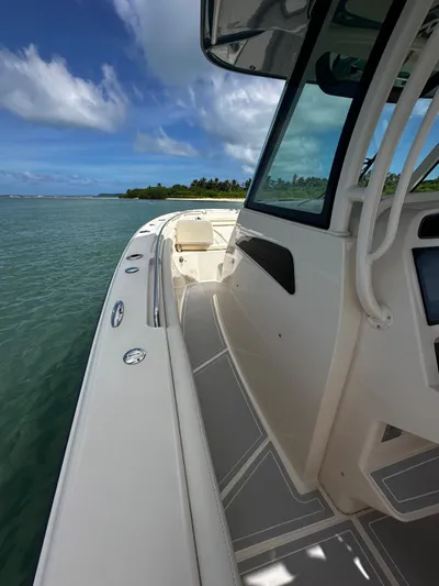  Yacht Photos Pics 2021 Grady-White Canyon 336 boat on clear water under blue sky.