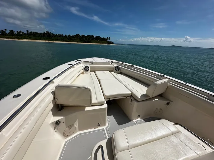  Yacht Photos Pics 2021 Grady-White Canyon 336 boat interior with seating, ocean view, and clear sky.