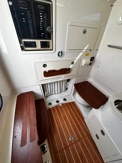  Yacht Photos Pics 2021 Grady-White Canyon 336 cabin interior with wood accents and control panel.