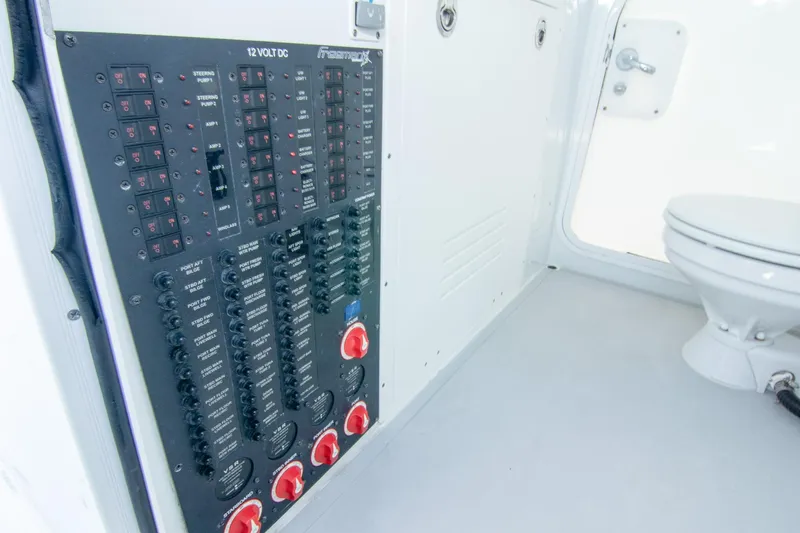  Yacht Photos Pics Electrical panel and toilet inside a 2022 Freeman 37 VH boat cabin.