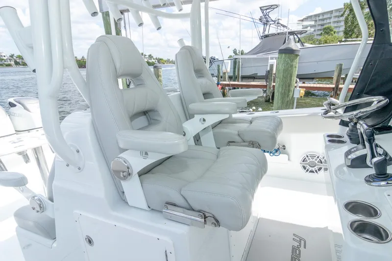  Yacht Photos Pics Luxury seating on 2022 Freeman 37 VH boat, featuring plush captain chairs and modern controls.