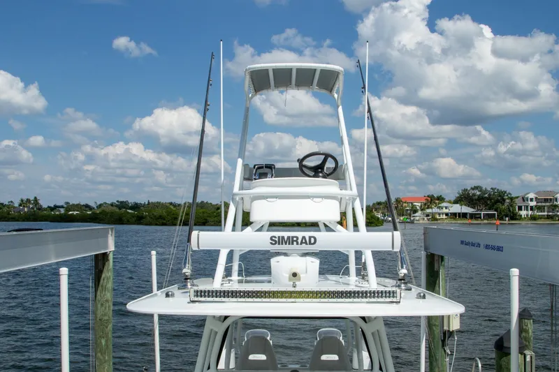  Yacht Photos Pics 2022 Freeman 37 VH boat docked by a scenic waterfront under a blue sky.
