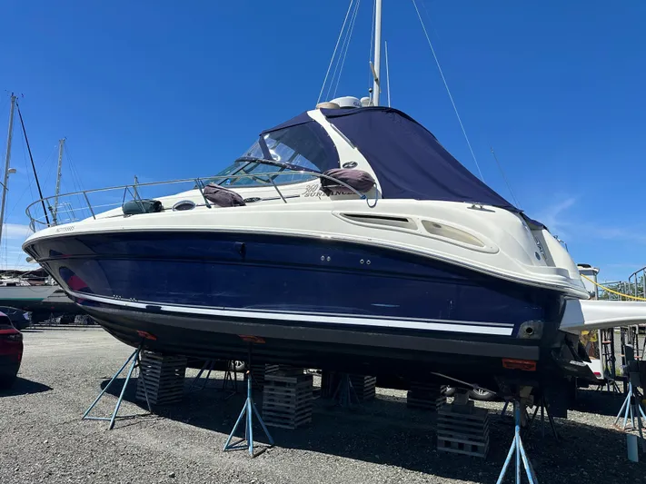  Yacht Photos Pics 2004 Sea Ray 360 Sundancer yacht on stands, blue hull, clear sky background.