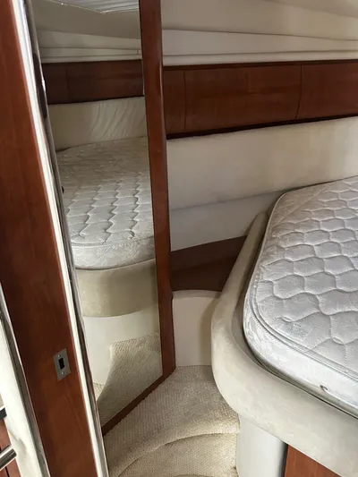  Yacht Photos Pics 2004 Sea Ray 360 Sundancer cabin interior with bed and mirror.