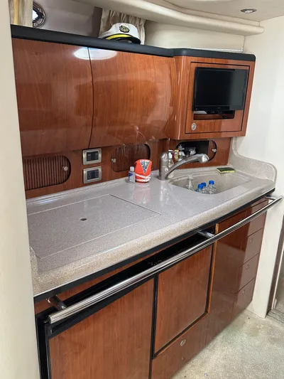  Yacht Photos Pics 2004 Sea Ray 360 Sundancer yacht kitchen with wood cabinetry and modern amenities.