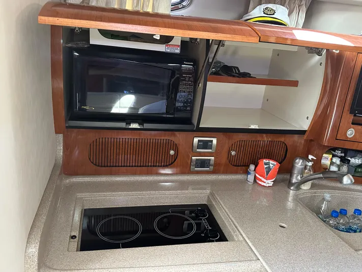  Yacht Photos Pics 2004 Sea Ray 360 Sundancer kitchen with microwave, stove, and sink.