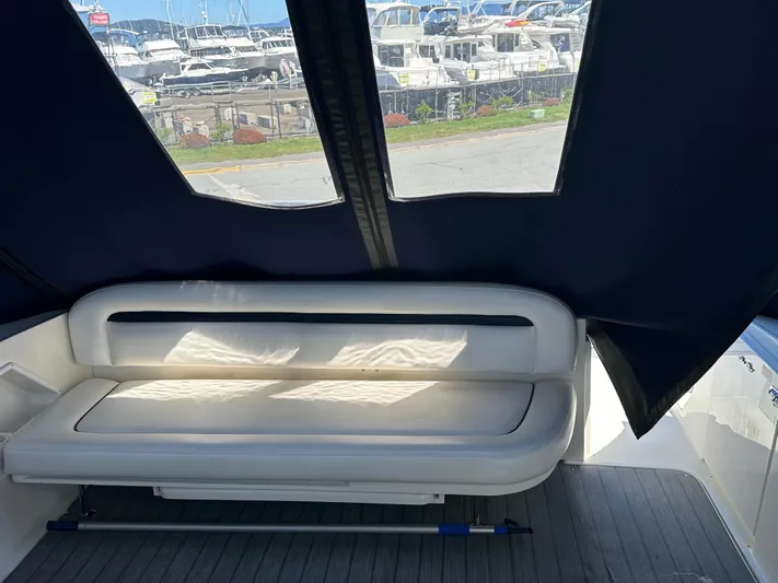  Yacht Photos Pics 2004 Sea Ray 360 Sundancer interior with cushioned seating and marina view.