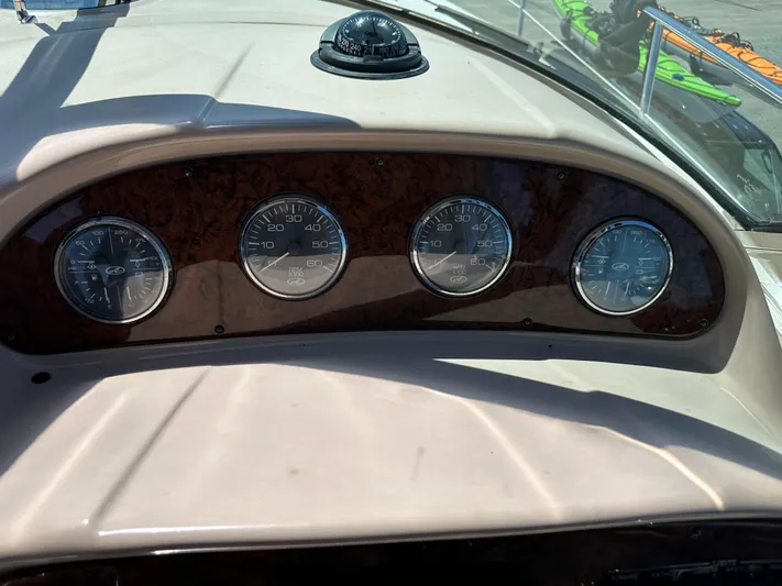  Yacht Photos Pics Dashboard of 2004 Sea Ray 360 Sundancer with gauges and compass in sunlight.