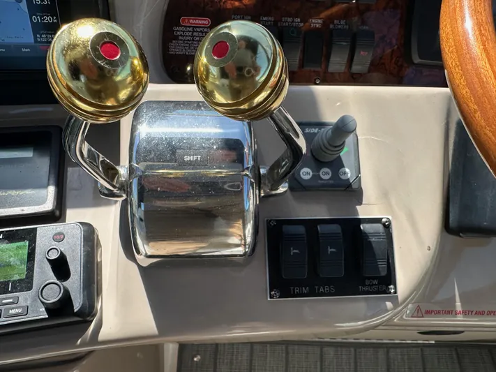  Yacht Photos Pics Control panel of a 2004 Sea Ray 360 Sundancer boat with throttle and navigation controls.