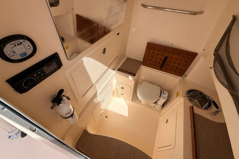  Yacht Photos Pics 2013 Grady-White Canyon 306 boat interior with toilet, sink, and storage compartments.