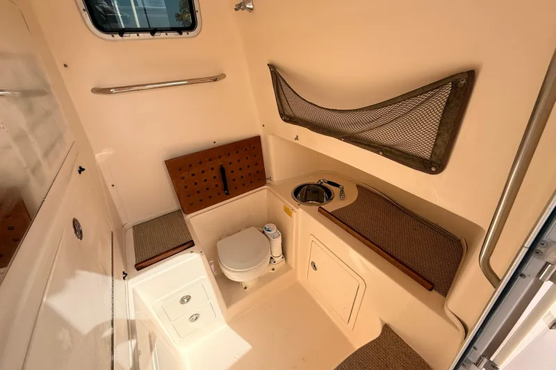  Yacht Photos Pics 2013 Grady-White Canyon 306 boat interior with toilet, sink, and storage.