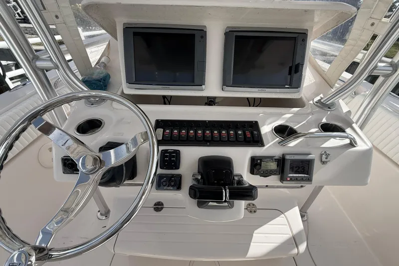  Yacht Photos Pics 2013 Grady-White Canyon 306 boat dashboard with steering wheel and navigation screens.
