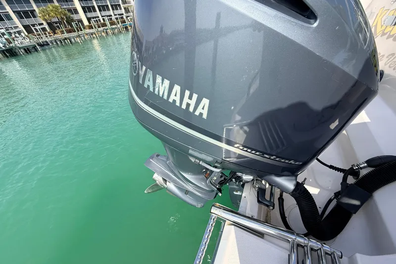  Yacht Photos Pics Yamaha outboard motor on 2013 Grady-White Canyon 306 boat, docked in clear water.