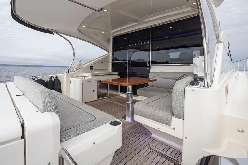 Lucky Dog Yacht Photos Pics 2018 Riviera 4800 Sport Yacht interior with elegant seating and ocean view.