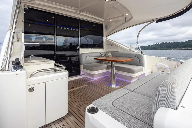 Lucky Dog Yacht Photos Pics 2018 Riviera 4800 Sport Yacht interior with elegant seating and scenic water view.