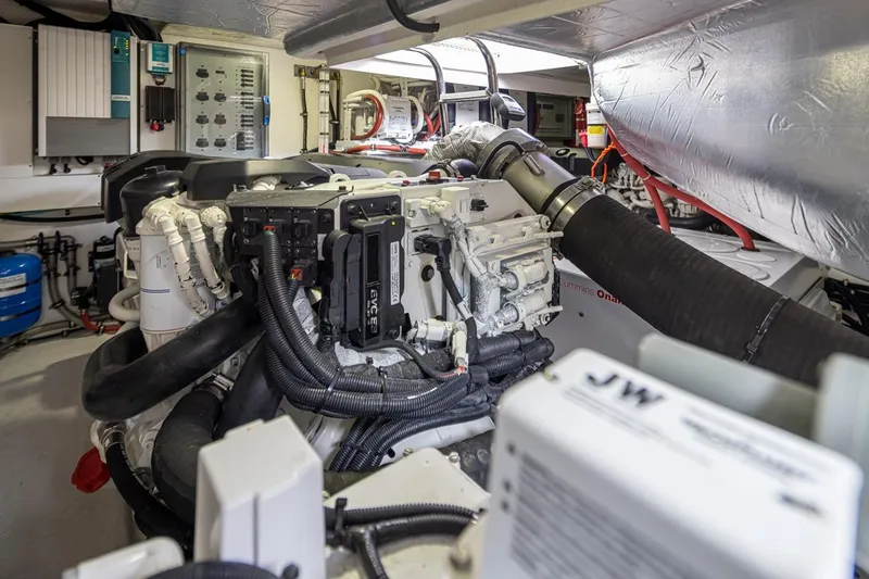 Lucky Dog Yacht Photos Pics Engine room of 2018 Riviera 4800 Sport Yacht, showcasing complex machinery and components.