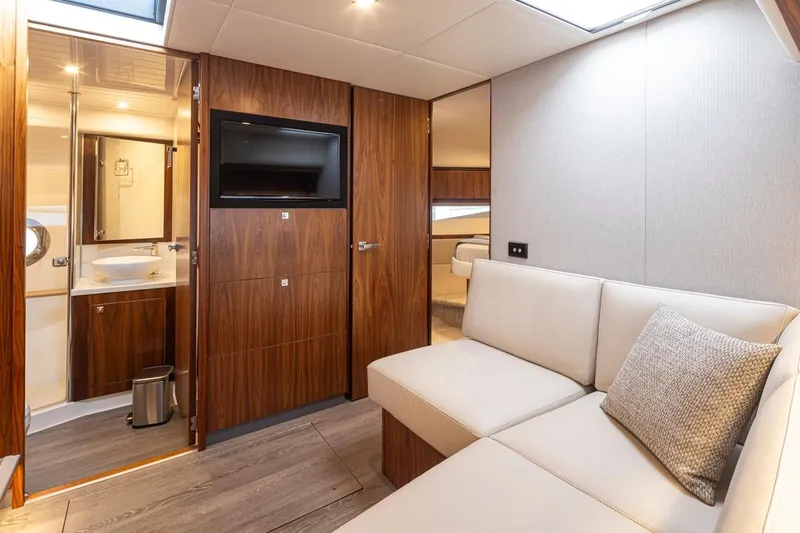 Lucky Dog Yacht Photos Pics Interior of 2018 Riviera 4800 Sport Yacht with modern furnishings and wood accents.