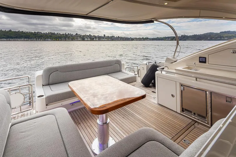 Lucky Dog Yacht Photos Pics Luxurious 2018 Riviera 4800 Sport Yacht interior with elegant seating and scenic water view.