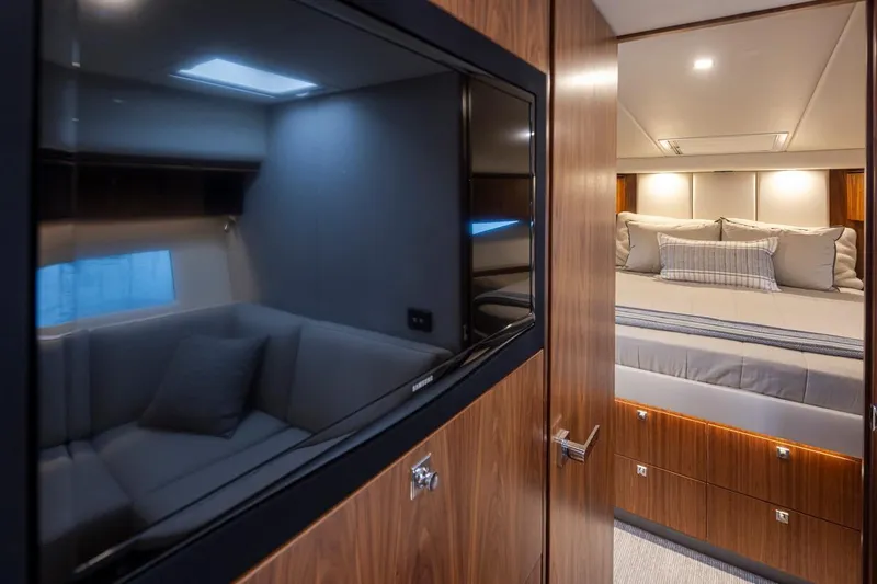 Lucky Dog Yacht Photos Pics Luxurious interior of 2018 Riviera 4800 Sport Yacht with cozy bedroom and modern amenities.