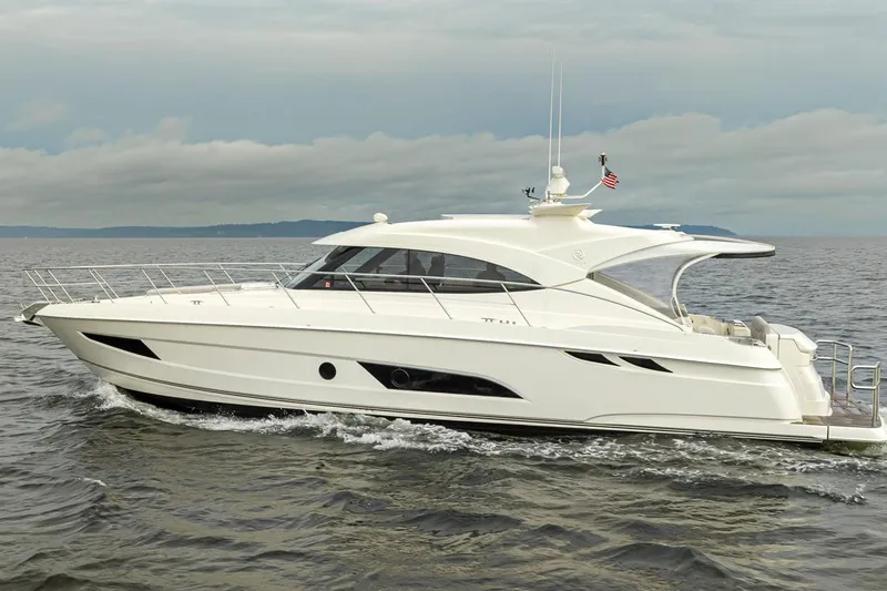 Lucky Dog Yacht Photos Pics 2018 Riviera 4800 Sport Yacht cruising on open water under cloudy skies.