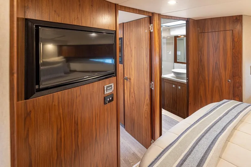 Lucky Dog Yacht Photos Pics Interior of 2018 Riviera 4800 Sport Yacht with wood paneling and modern amenities.