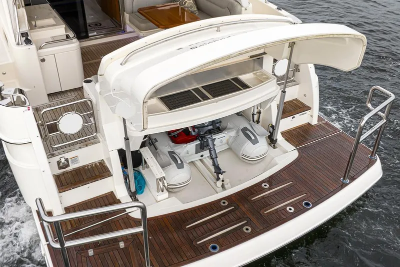 Lucky Dog Yacht Photos Pics 2018 Riviera 4800 Sport Yacht with open engine compartment on teak deck.