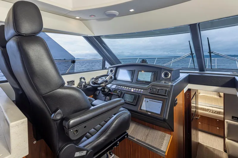Lucky Dog Yacht Photos Pics 2018 Riviera 4800 Sport Yacht helm with leather captain's chair and advanced navigation systems.