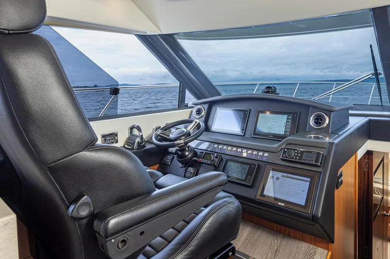 Lucky Dog Yacht Photos Pics 2018 Riviera 4800 Sport Yacht helm with modern navigation systems and ocean view.
