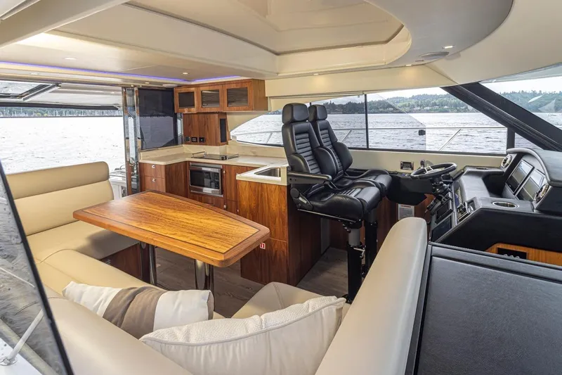 Lucky Dog Yacht Photos Pics Luxurious interior of 2018 Riviera 4800 Sport Yacht with modern kitchen and helm.