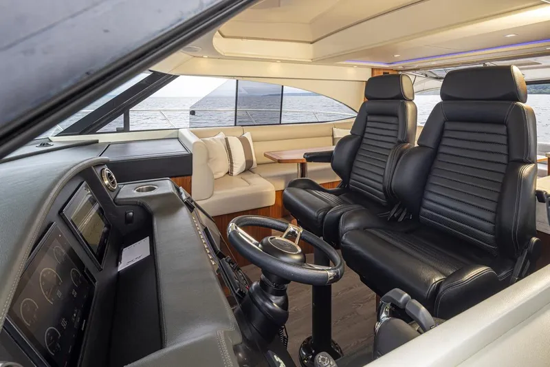 Lucky Dog Yacht Photos Pics Interior of 2018 Riviera 4800 Sport Yacht with luxurious seating and ocean view.